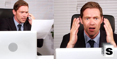 Stressed Business Man Throws Papers in Office