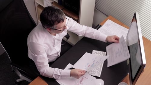 CFO In Front Of Monitor's Computer and Works