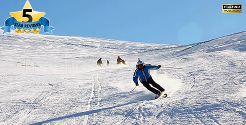 People Skiing Down Snow Covered Mountain on Sunny Day