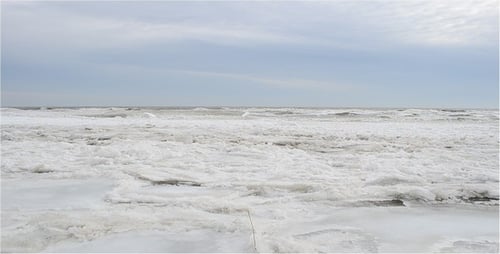 Icy Shoreline and Ocean Waves in Winter
