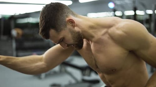 Fitness Man Athlete Training Hand Muscles Enjoying Difficult Endurance Practice in Gym