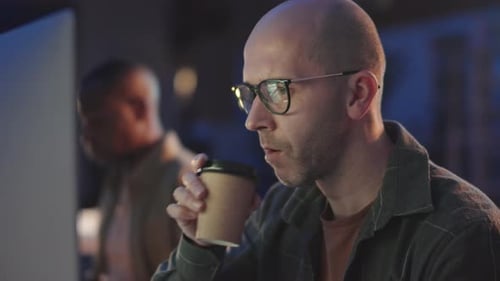 Software Developers Working in Office at Night