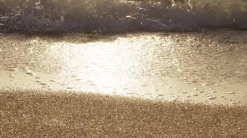 Golden Sunset on a Beach Slow Motion of Foamy Waves Rolling Towards Sandy Beach
