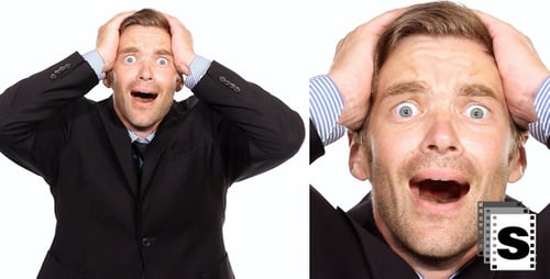 Stressed Man in Suit Holding Head on White