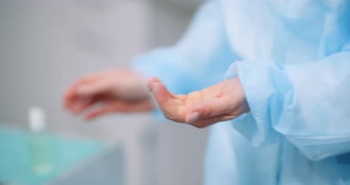 Surgical Hand Disinfection. - Woman Disinfecting Hands at Health Care Clinic