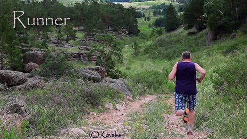 Man Running on a Dirt Road in the Countryside