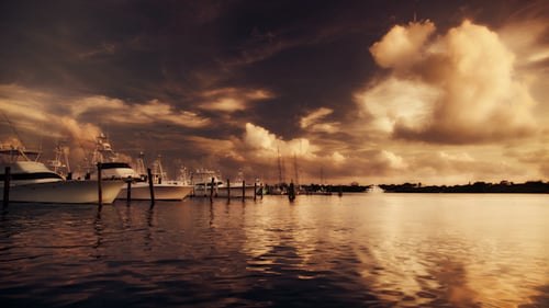 Sunset Over Harbor with Boats Docked at Pier