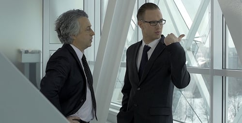 Two Men Talking Business in Modern Building