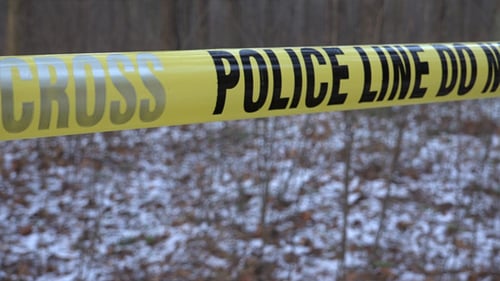 Police Tape Blocks Winter Forest Scene