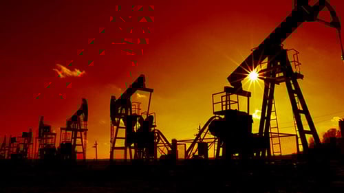 Oil Pump Jacks Silhouetted at Sunrise or Sunset