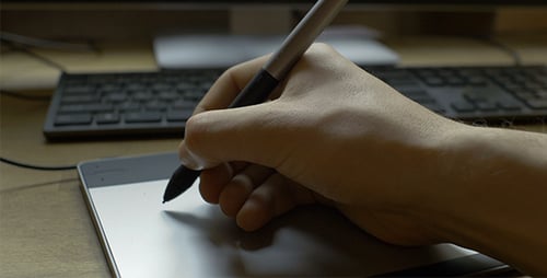 Hand Using Stylus and Digital Tablet Close Up