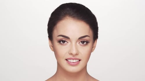 Studio portrait of young and beautiful brunette woman over