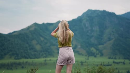 Female Tourist Adjusts Shorts and Shakes Hair at Eco Reserve