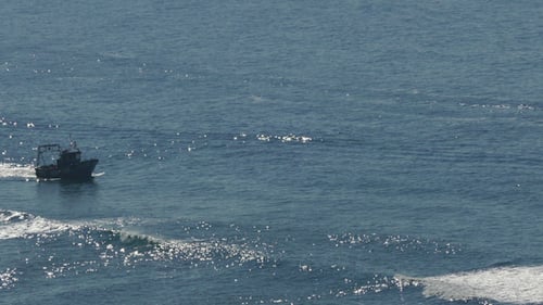 Fishing Boat Floating on the Ocean Waves