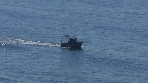 Fishing Boat Floating on the Ocean Waves