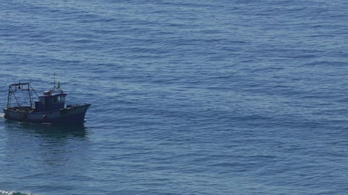 Fishing Boat Floating on the Ocean Waves