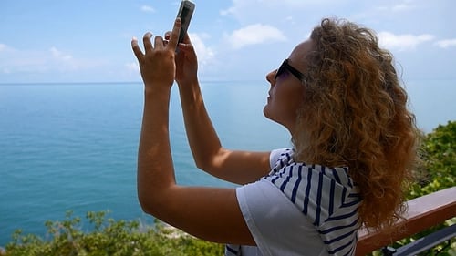 Woman Taking Photos of Tropical Ocean View