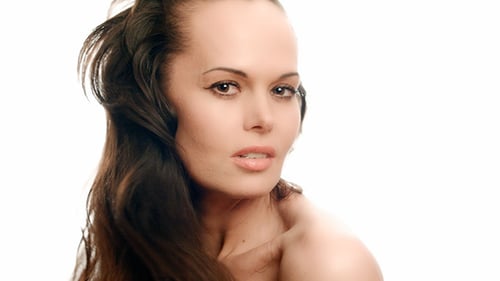 Attractive Woman Tossing Her Long Hair in Studio
