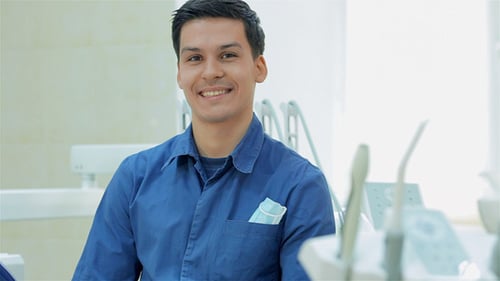 Dentist Smiling Before Taking The Patient