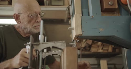 Senior Adult Working with Wrench in Workshop