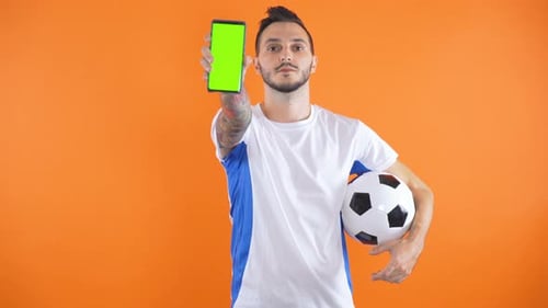 футбольный болельщик с ноутбуком и смартфоном