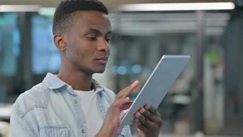 Young Adult Using Tablet Device in Office Setting