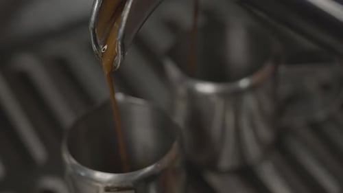 Close-up of Espresso From Coffee Machine. Professional Barista Coffee Brewing in Coffee Shop.