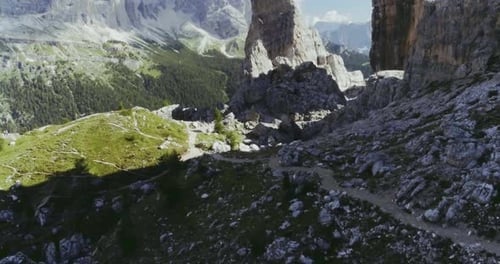 Aerial Flight Above Mountain Top with Pines and Rocks in Sunny Day