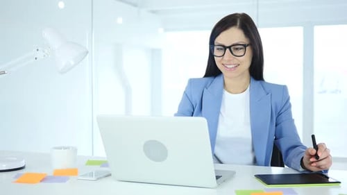 Woman Working at Desk with Graphics Tablet