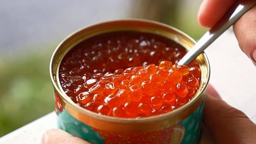 Spoon Scooping Red Caviar from a Can