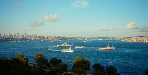 Scenic Cityscape with Boats Crossing the Waterway
