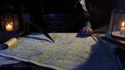 Medieval Person Studying Map By Candlelight