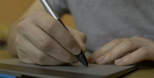 Hand Using Stylus on Graphics Tablet Close Up