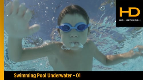 Child Swimming Underwater in Outdoor Swimming Pool