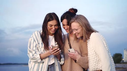 Three Women Friends Looking at Smartphone Together