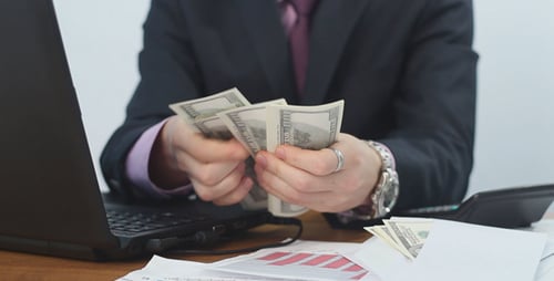 Empresário conta dólares no escritório