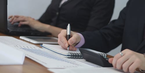 Business People Reviewing Data and Charts