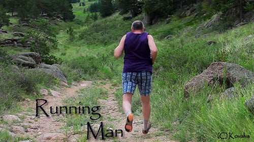 Adult Man Runs Down Dirt Trail in Nature