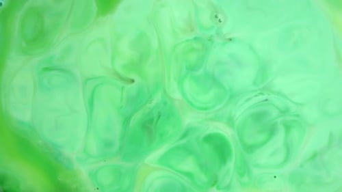 Footage. Ink in Water. Green Ink Reacting in Water Creating Abstract Background.