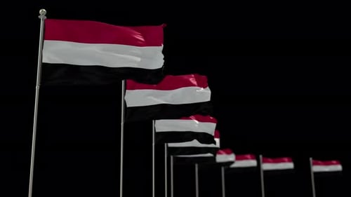 Waving Yemen Flags Against a Black Background