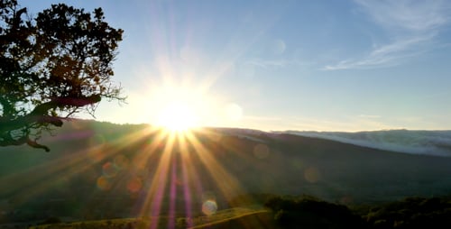 Sunrise over the Hills with Golden Sun Beams
