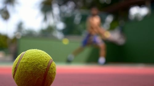 Close Up Of A Tennis Ball And Player