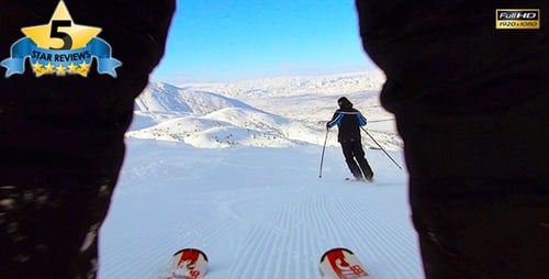 Two Skiers Descend Snow Covered Mountain on Skis