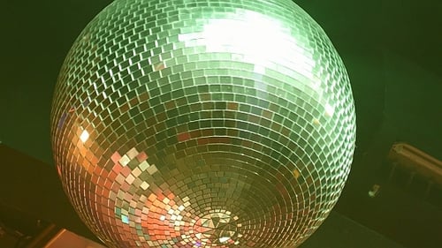 Disco Ball Reflecting Colorful Lights in Nightclub