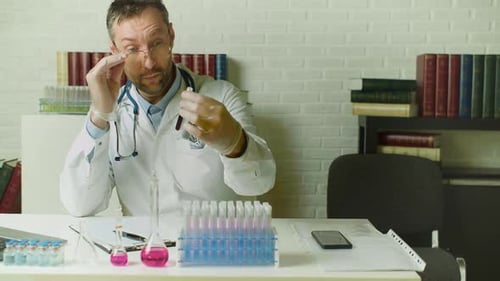 Scientist Analyzing Test Tube in Well Lit Laboratory