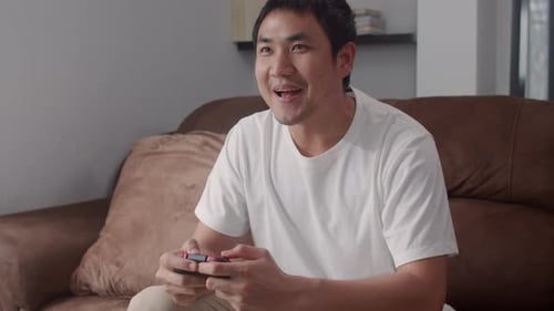 Man Playing Video Games on Couch in Living Room