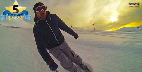 Man Skiing Down Snowy Mountain Slope