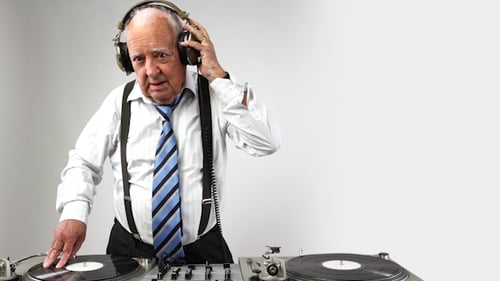 Senior Man Working a DJ Turntable Mixer