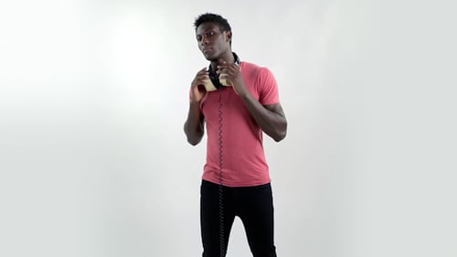 Young Adult Posing with Vintage Headphones in Studio