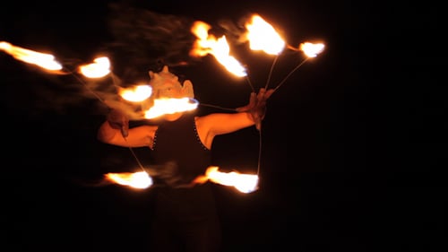Mesmerizing Fire Dancer Performing with Flaming Torches